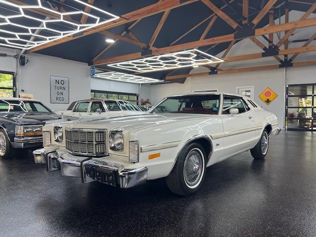 1975 Ford Elite — white with wire wheels in showroom